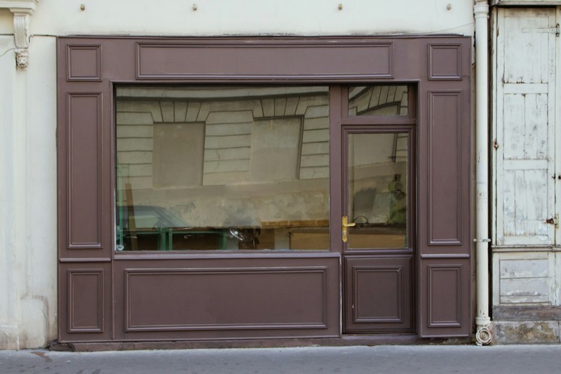 Shop window with the reflection of a car on the glass